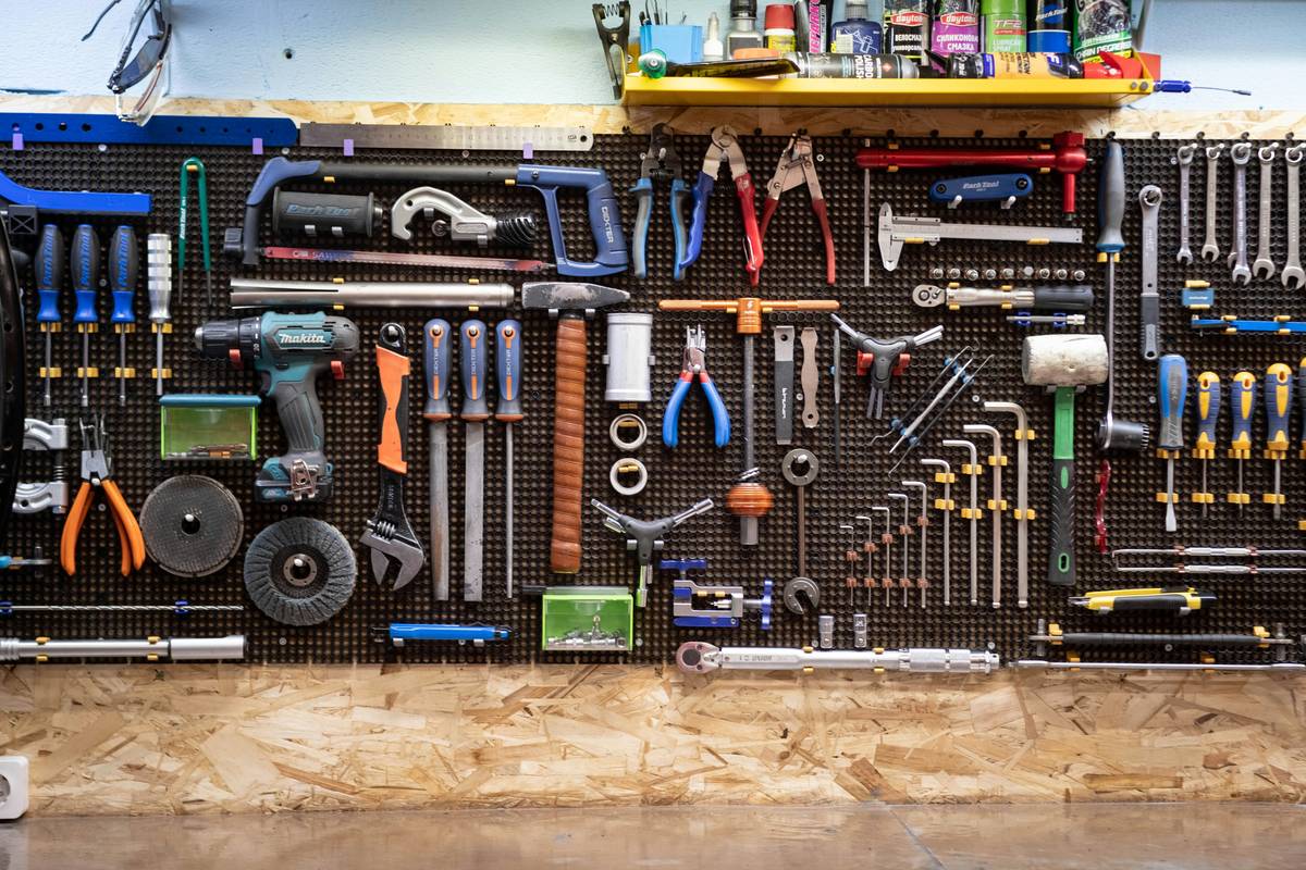 Top diy home improvement tips shown through a homeowner fixing a leaky faucet with proper tools and safety gear