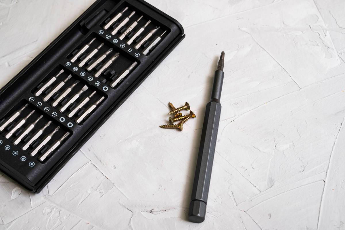 diy home maintenance checklist on a workbench with tools and a notebook